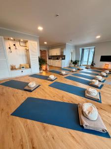a yoga class with blue mats on the floor at Hotel Haus am See in Lembruch