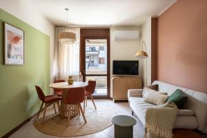 a living room with a couch and a table at Calm House in Desenzano del Garda
