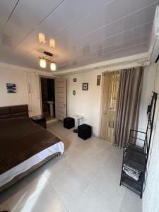 a bedroom with a bed and a chair in it at Green House მწვანე სახლი in Sighnaghi