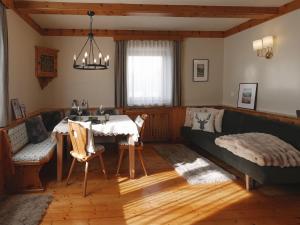 a living room with a couch and a table at Holiday home with panoramic views in Tulfes