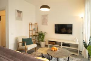 a living room with a couch and a table at Assuta family in Tel Aviv