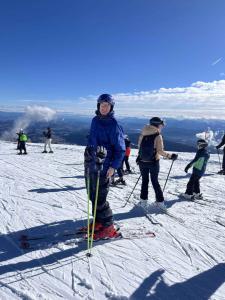 a group of people standing on top of a ski slope at Pension Pilsachhof in Arriach