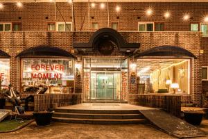a front door of a building with a sign that reads forever woman at Jeju EQ Stay Hotel in Jeju +56 photos