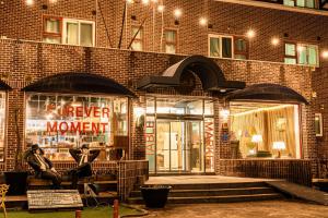 a store front of a brick building at night at Jeju EQ Stay Hotel in Jeju