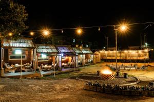 a group of buildings at night with lights at Jeju EQ Stay Hotel in Jeju