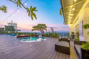 a view from the roof of a building with a swimming pool at Hotel Ciputra Cibubur managed by Swiss-Belhotel International in Cibubur