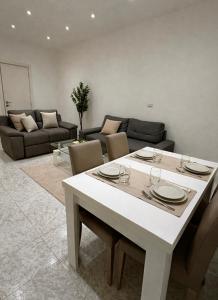 a white table and chairs in a living room at The Urban Lodge in Bari