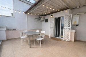 a patio with a table and chairs in a building at The Urban Lodge in Bari