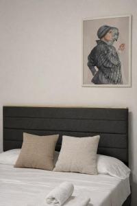 a bedroom with a bed with a picture above it at The Urban Lodge in Bari