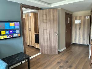 a living room with wooden cabinets and a television at Han Residence Haliç in Istanbul