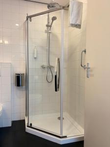 a shower with a glass door in a bathroom at Hotel Bieze in Borger +45 photos