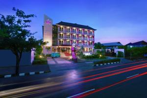 a building on a city street at night at Fame Hotel Sunset Road in Kuta