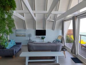 a living room with a couch and a table at Awesome AFrame in Witsand