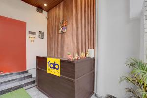 a lobby with a sign on the side of a building at FabHotel Swastik Villa in Varanasi