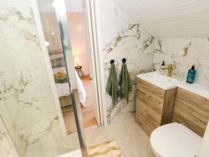 a bathroom with a shower and a toilet and a sink at Graig Goch in Burry Port +32 photos