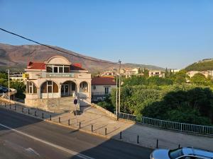 a building sitting on the side of a road at Apartmani Mašić Trebinje in Trebinje
