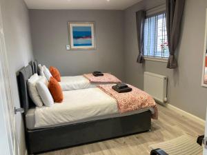 a bedroom with two beds and a window at The Dairy in Airdrie