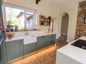 a kitchen with a sink and a window at Yew Tree Cottage in Wigton +34 photos