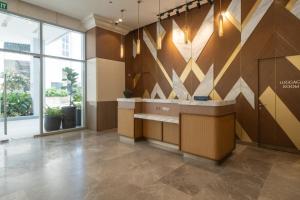 a lobby with a reception desk in a building at Belmont Hotel Iloilo in Iloilo City