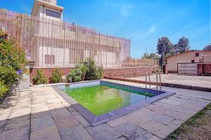 a swimming pool in the yard of a house at FabHotel Aaryras Heritage Resort in Mahabaleshwar