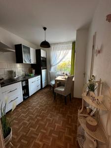a kitchen with a table and a dining room at Apartments Vogtlandblick in Reichenbach im Vogtland