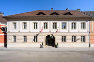 a large white building with two flags in front of it at Buda Castle Hotel Budapest in Budapest +45 photos