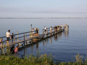 a group of people on a dock in the water at DCU-Camping Åbyskov Strand in Åbyskov