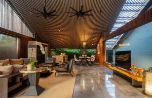 a living room with a couch and a fireplace at Ametis Villa Bali in Canggu
