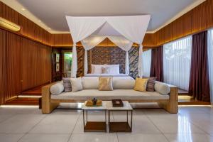 a living room with a couch and a bed at Ametis Villa Bali in Canggu +62 photos