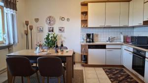 a kitchen with a table with chairs and a sink at FW Scheifele in Zwiesel