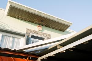 a building with a sign on the side of it at CELCOR PENSION HOUSE in Cabatuan