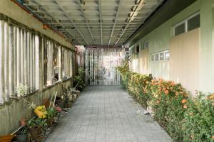 an empty hallway with flowers in a building at CELCOR PENSION HOUSE in Cabatuan