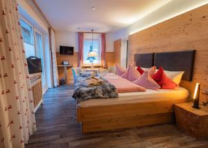 a bedroom with a bed with pillows on it at Almhotel Grünsteinblick - Adults only in Königssee