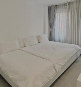 a white bed in a room with a window at PHAM Homes in Hai Phong