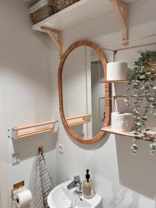 a bathroom with a sink and a mirror at Cosy guesthouse in peaceful garden surroundings in Silkeborg +19 photos