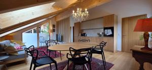 a kitchen and dining room with a table and chairs at Johler Appartements in Bezau