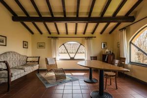a living room with a table and a couch at Podere Magnolia in Pisa
