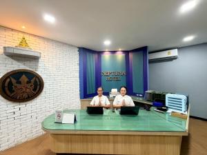 two women sitting at a desk with their laptops at Blue Neptuna Hotel Patong in Patong Beach