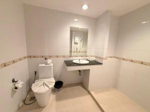 a bathroom with a toilet and a sink at Blue Neptuna Hotel Patong in Patong Beach