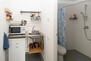 a small bathroom with a sink and a microwave at Assuta studio in Tel Aviv +47 photos