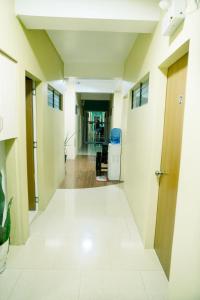 an empty hallway of an office building with a door at CELCOR PENSION HOUSE in Cabatuan