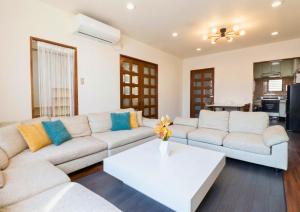 a living room with a couch and a table at en stay001 in Osaka