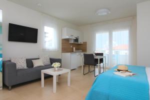 a living room with a couch and a table at Studio Emanuel in Rovinj