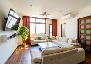 a living room with a couch and a table at en stay001 in Osaka