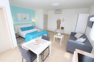a room with a bed and a couch and a table at Studio Emanuel in Rovinj +34 photos