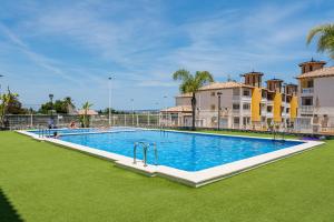 a large swimming pool in front of some buildings at Playa del Pinet 2 in La Marina