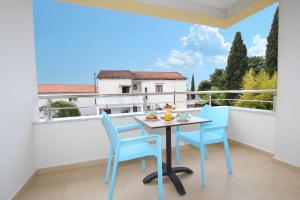 a balcony with a table and chairs and a view at Studio Emanuel in Rovinj
