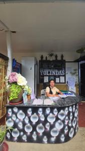 a young child sitting at a table in a room at YOLINDA's TOURIST INN in El Nido