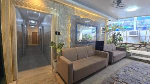 a living room with a couch and a mirror at YOLINDA's TOURIST INN in El Nido