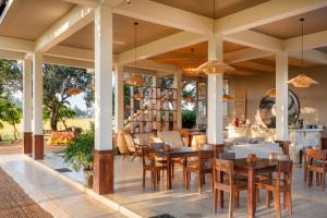 an outdoor dining area with tables and chairs at Serene Park Hotel By Ark in Tissamaharama